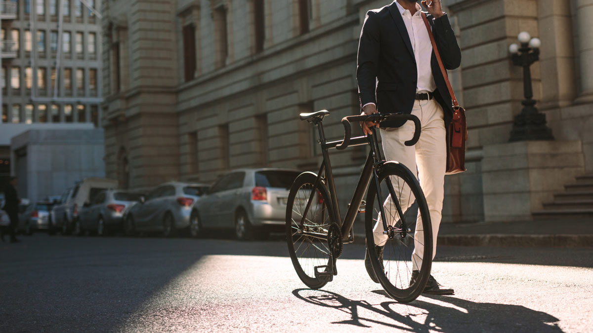 Man med cykel pratar i telefon
